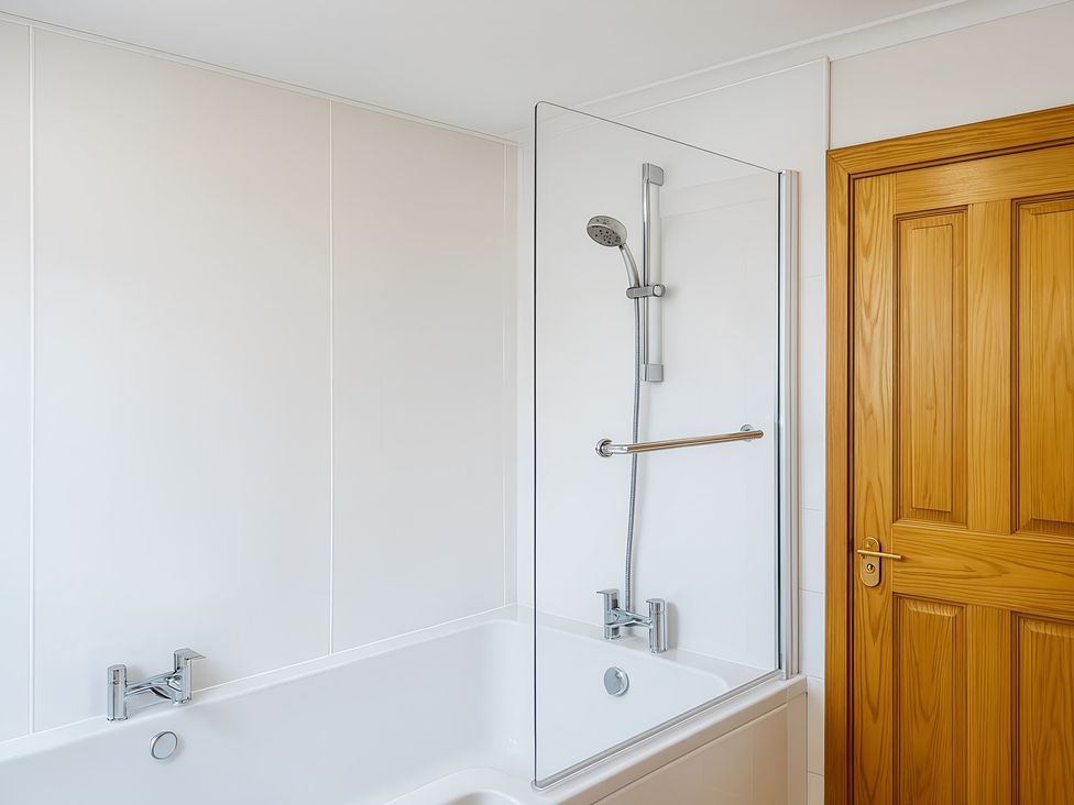 A bathroom with a bathtub and shower at Culnacraig in Stranraer