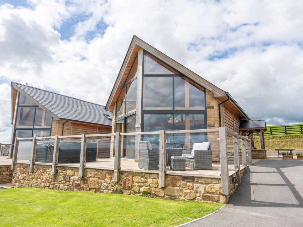 A building with large windows and a deck at Valley View Lodge 1 Preston