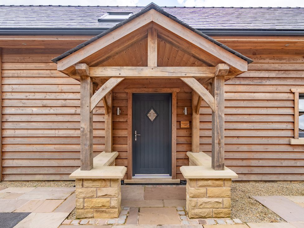 An entrance with a wooden gazebo and stone benches at Valley View Lodge 1 Preston