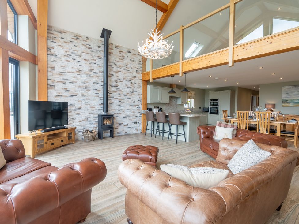 A living room with a fireplace and television at Valley View Lodge 1 in Preston