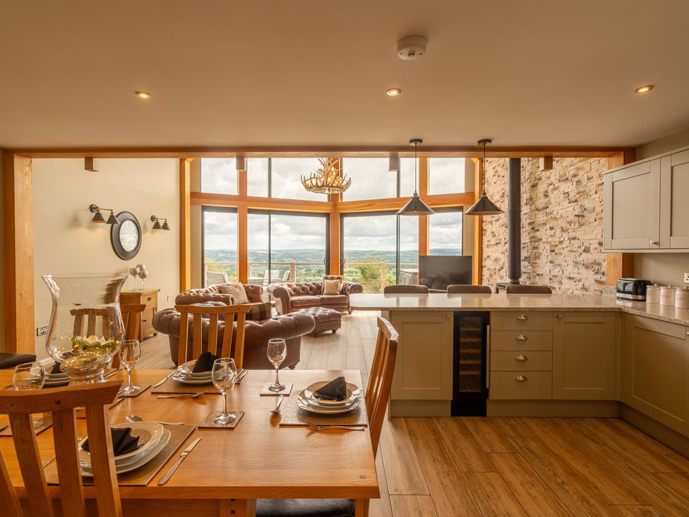 A dining area and living room with seating and kitchen features at Valley View Lodge 1 Preston