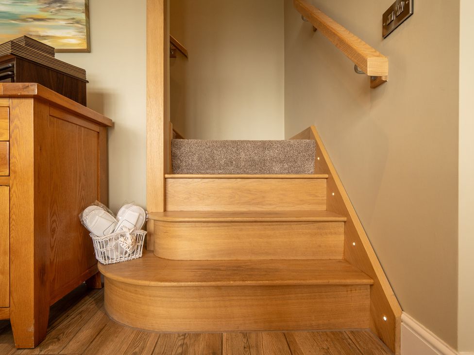 A staircase with wooden steps and railing at Valley View Lodge 1 Preston