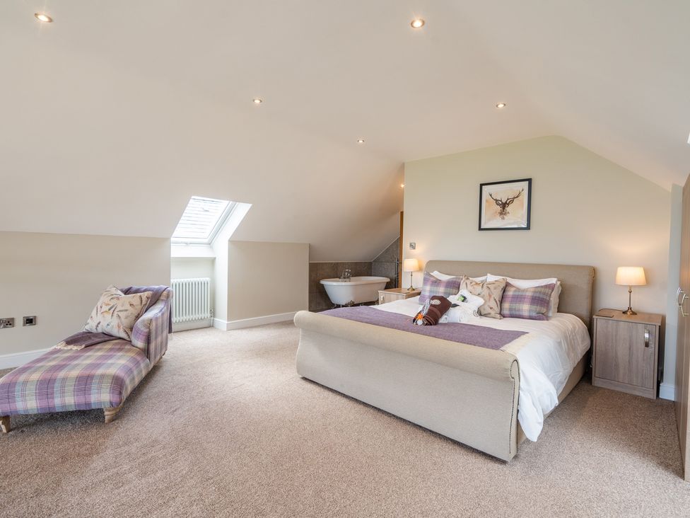 A bedroom with a bed and a bath tub at Valley View Lodge 1 in Preston