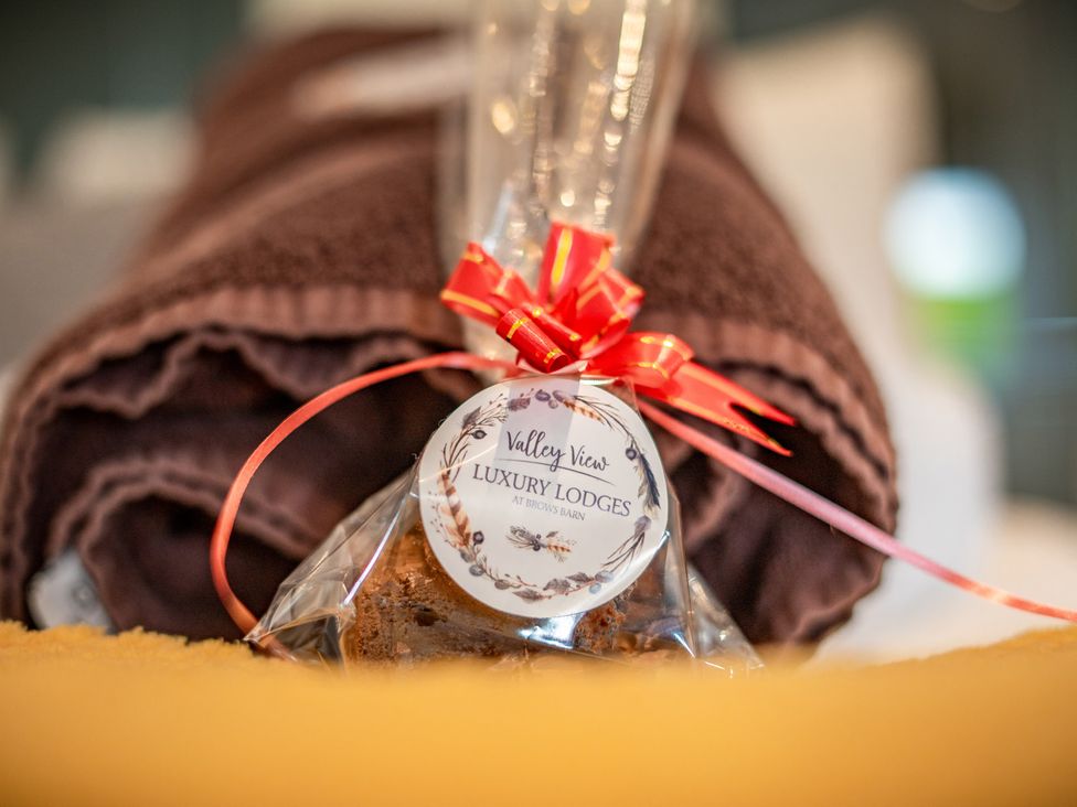 A towel with a wrapped cake and gift tag at Valley View Lodge 1 Preston
