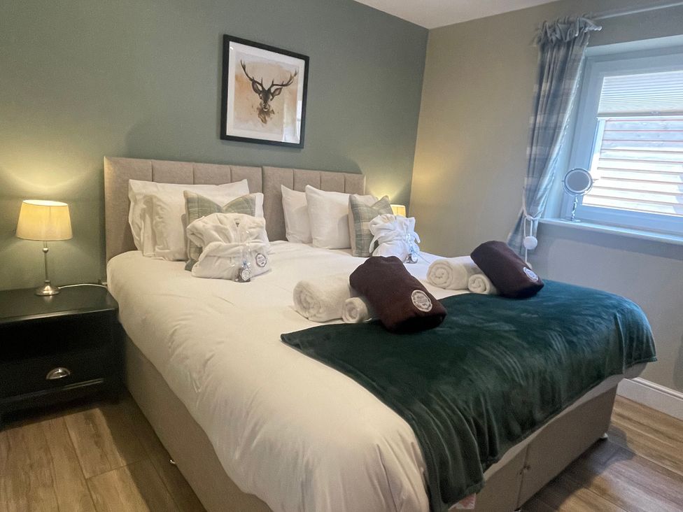 A bedroom with a bed and bedside table at Valley View Lodge 1 Preston