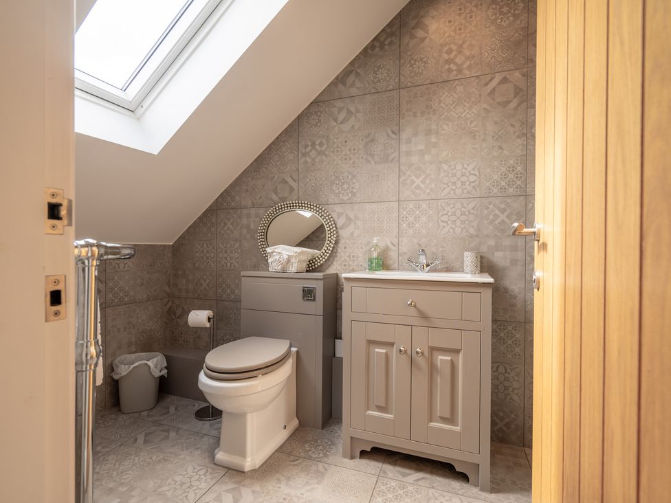A bathroom with a toilet, sink, and mirror at Valley View Lodge 1 Preston