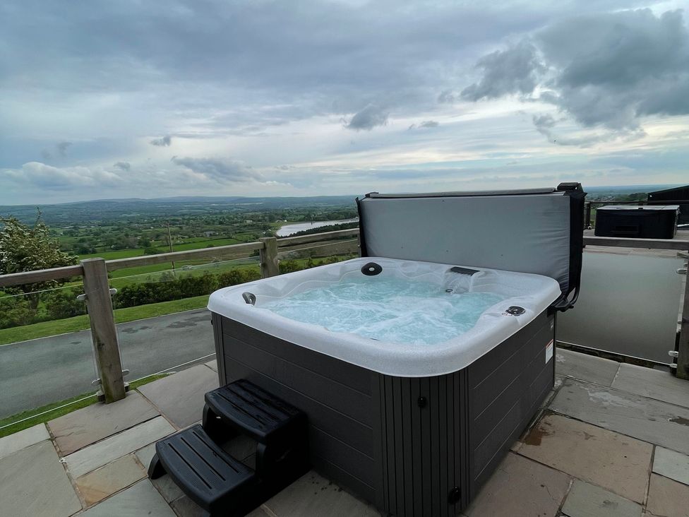 A hot tub on a patio with a view at Valley View Lodge 1 Preston