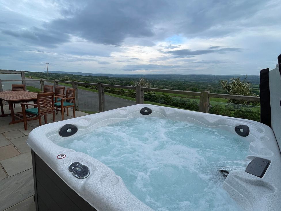 A hot tub and dining area with view at Valley View Lodge 1 Preston