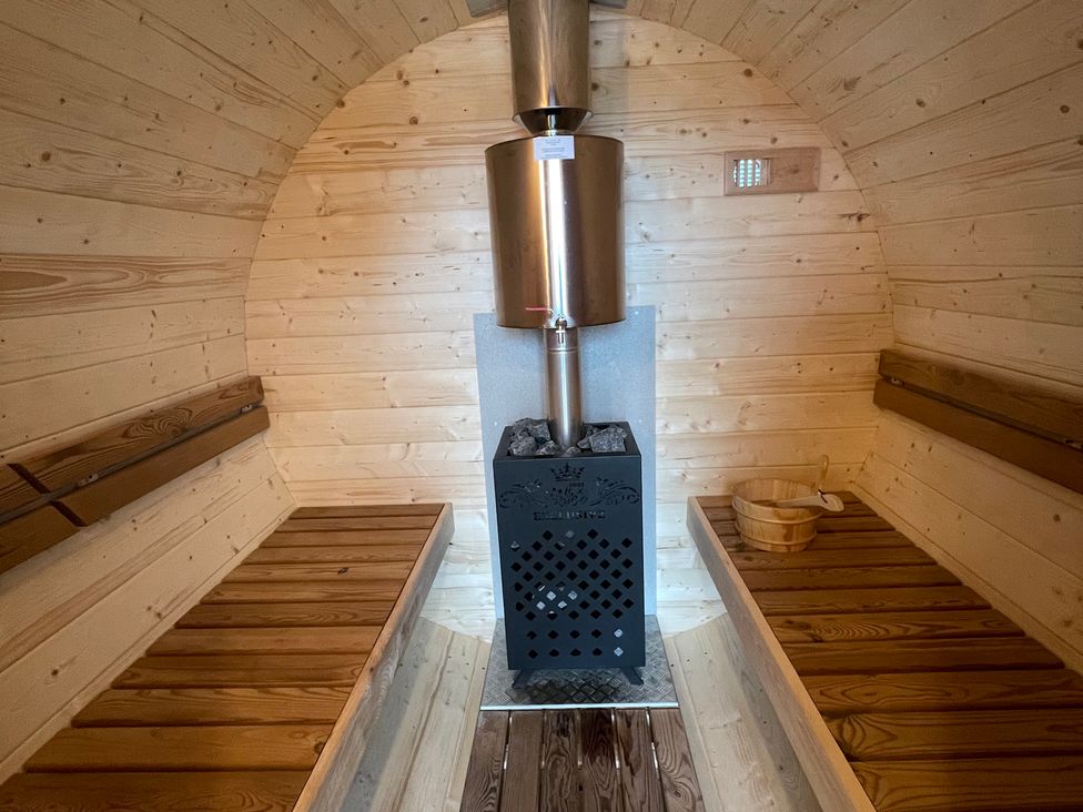 A sauna with wooden benches and a stove at Valley View Lodge 1 Preston