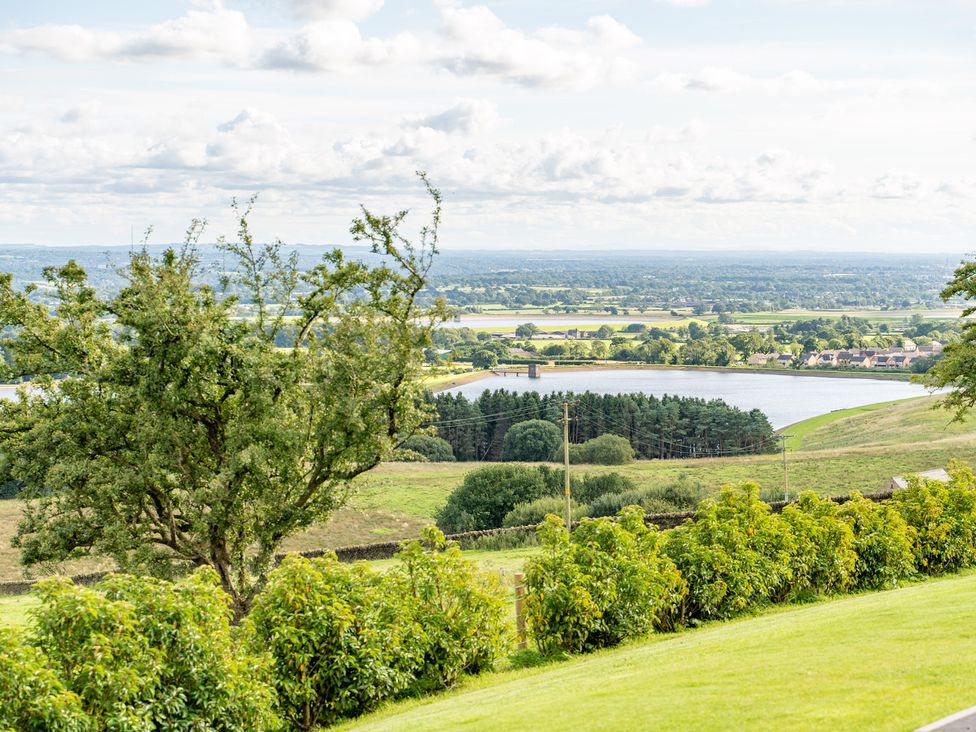 A landscape view with trees, river and fields at Valley View Lodge 1 Preston