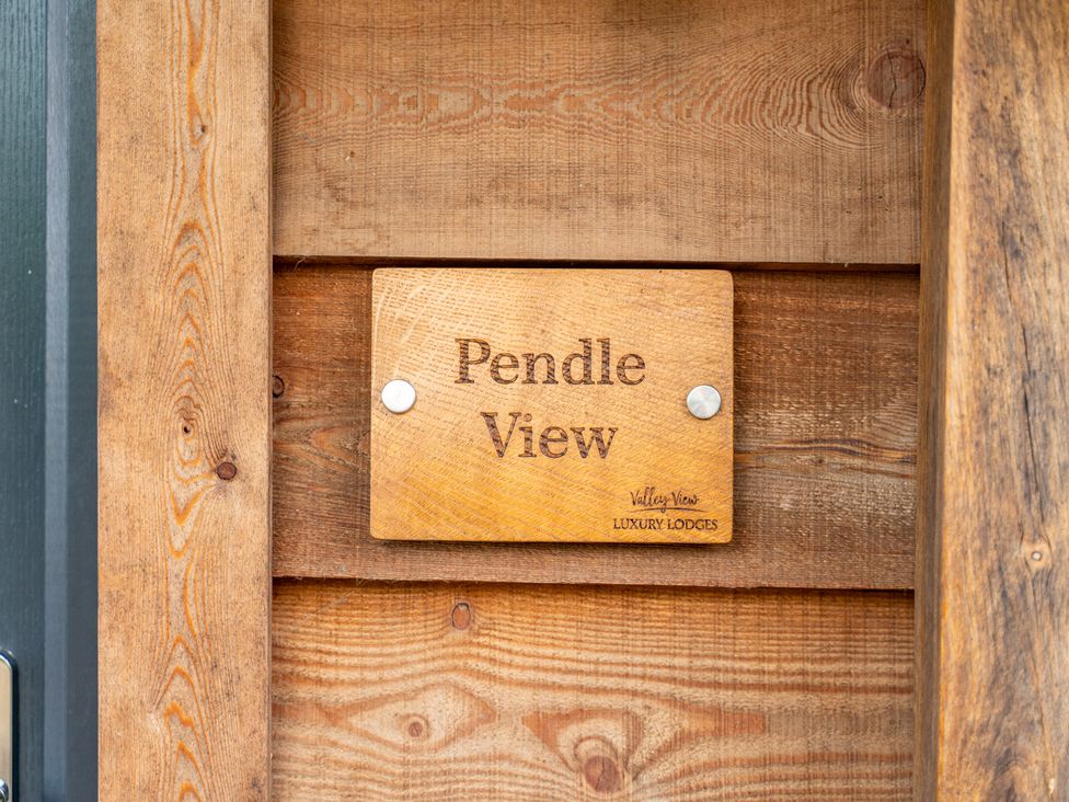 A wooden sign stating Pendle View at Pendle View Preston