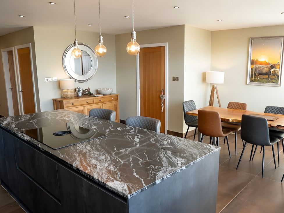 A kitchen with an island and dining area at Pendle View in Preston