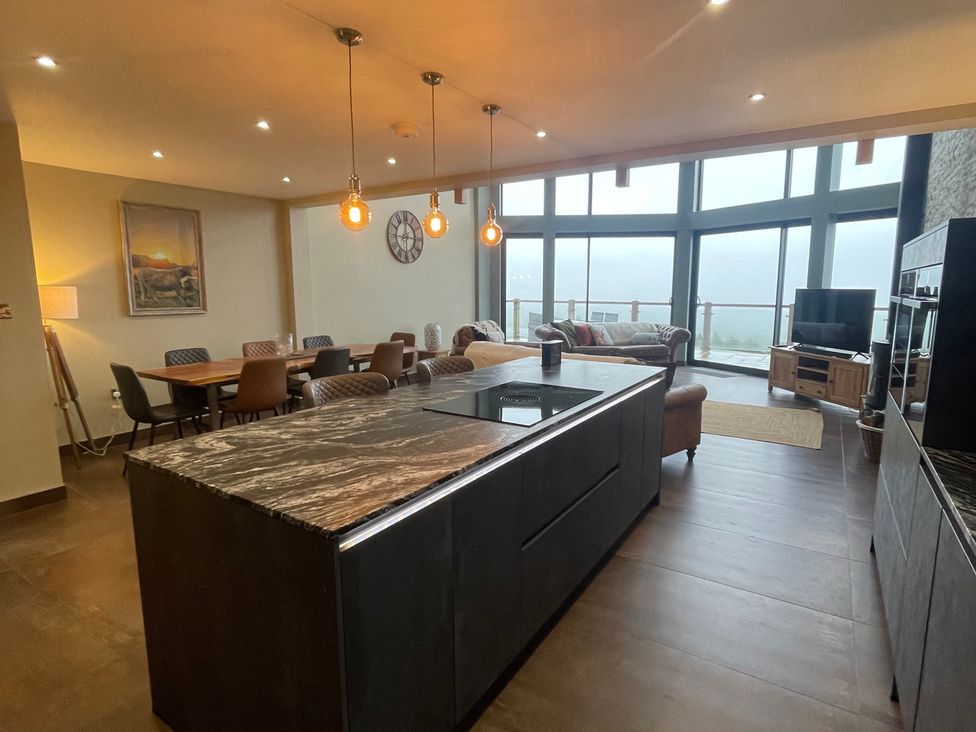 A kitchen with an island and dining area at Pendle View Preston