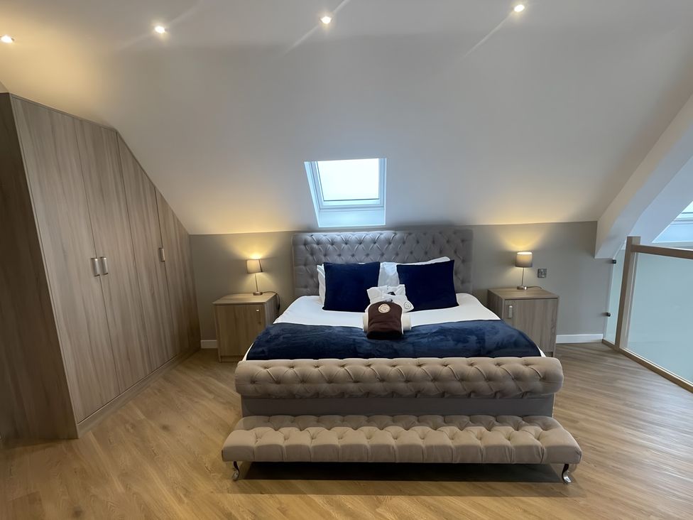 A bedroom with a bed and bedside tables at Pendle View Preston
