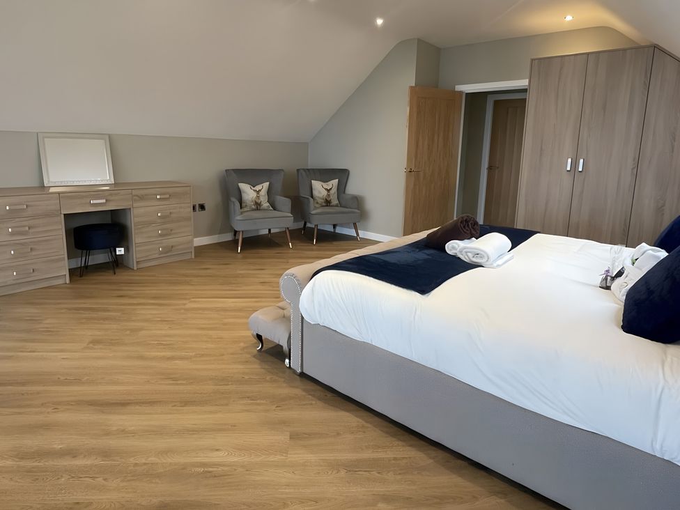A bedroom with a bed and dresser at Pendle View Preston