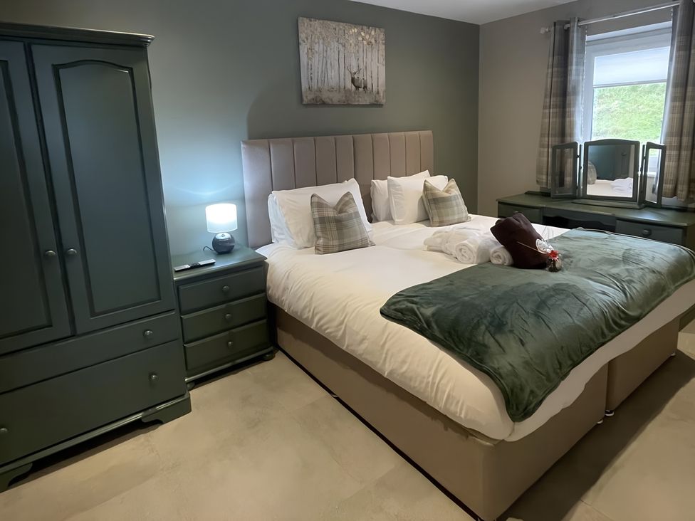 A bedroom with a bed and wardrobe at Pendle View Preston