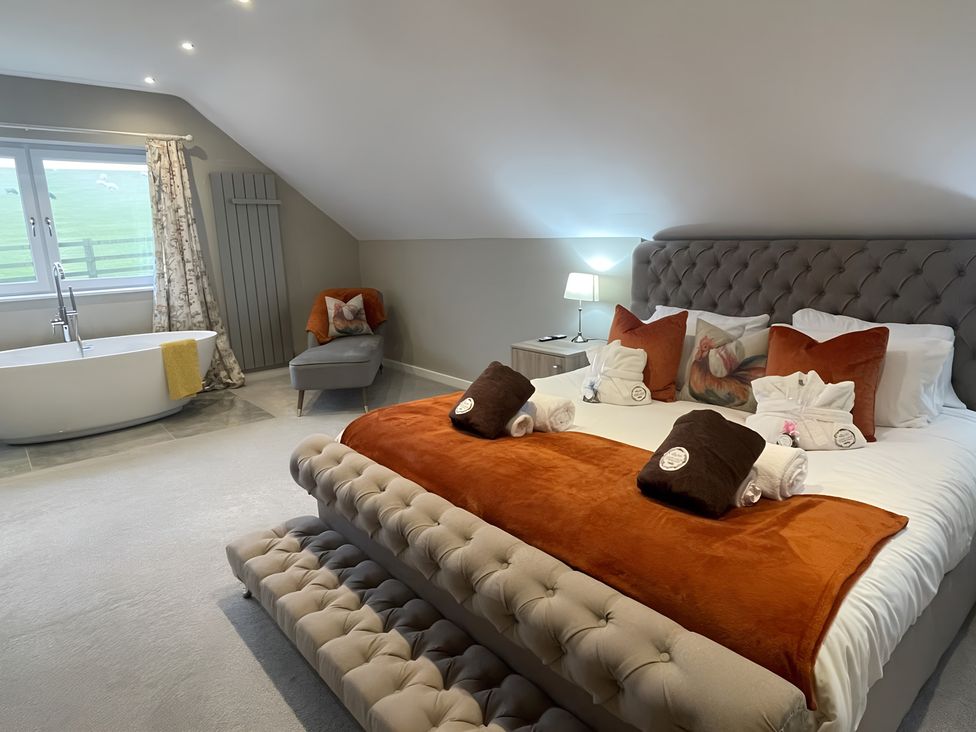 A bedroom with a bed and a bathtub at Pendle View in Preston