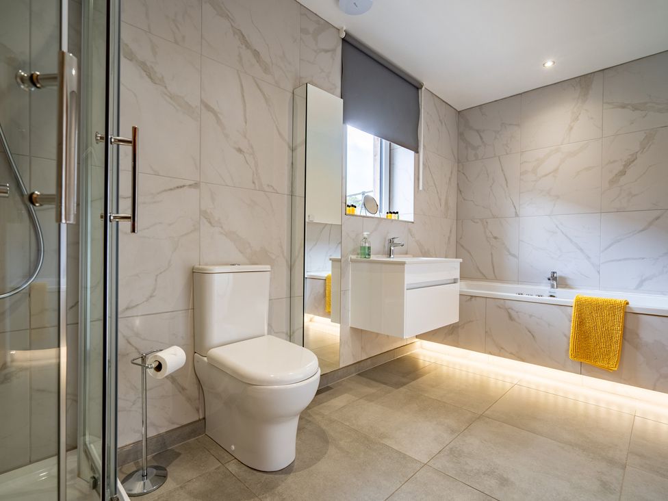 A bathroom with a shower, sink, toilet, and bathtub at Pendle View Preston