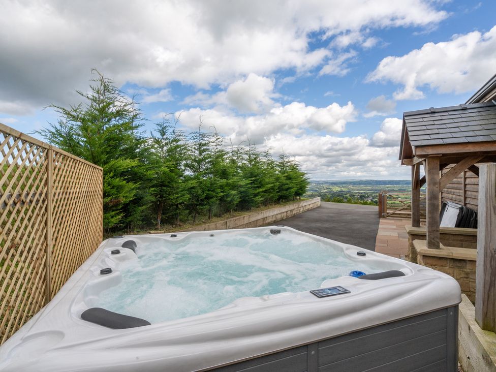 An outdoor area with a hot tub and fence at Pendle View in Preston