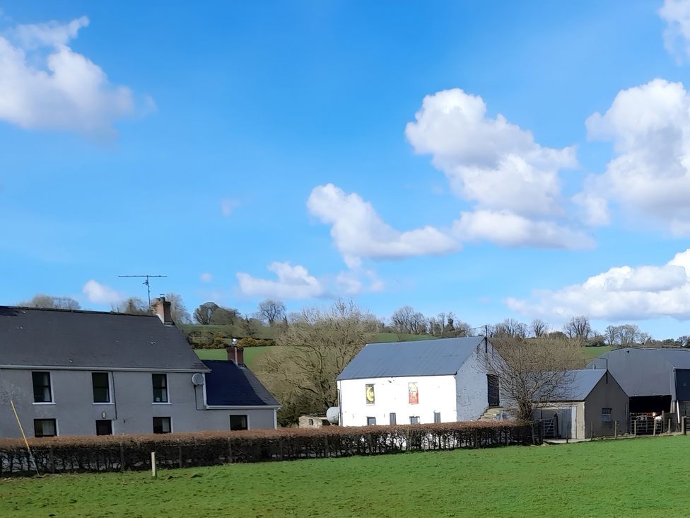 A view of houses and barns in a field at The Farmhouse in Omagh