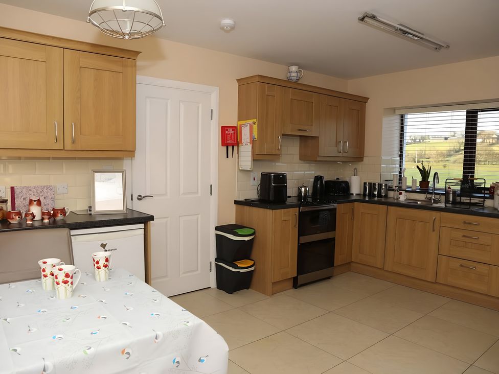 A kitchen with cabinets and appliances at The Farmhouse in Omagh