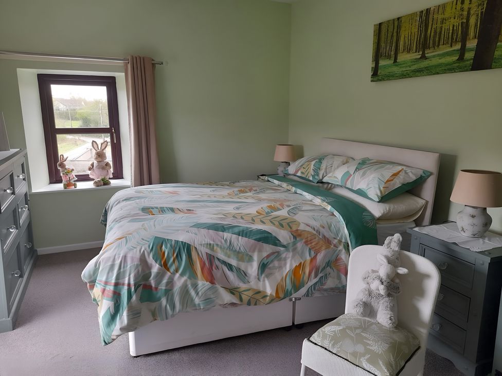 A bedroom with a bed and dresser at The Farmhouse in Omagh