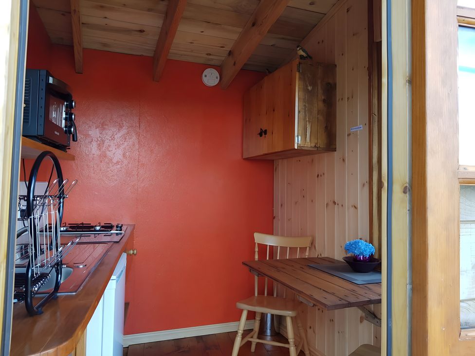 A kitchen with a stove and sink at Bryn Mawr Cabin in Craven Arms