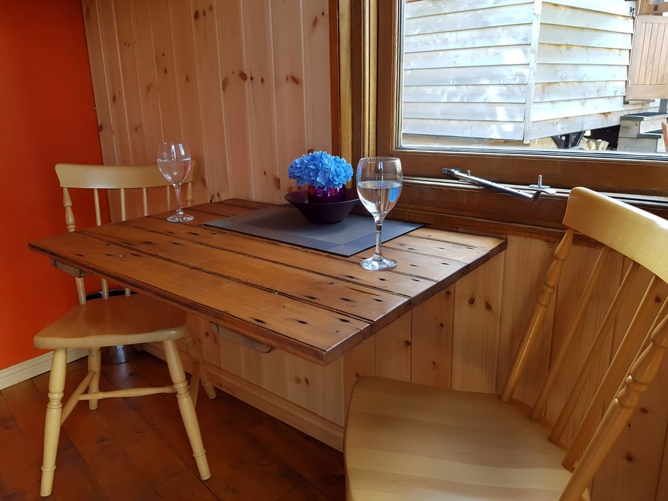 A dining area with a table and chairs at Bryn Mawr Cabin in Craven Arms