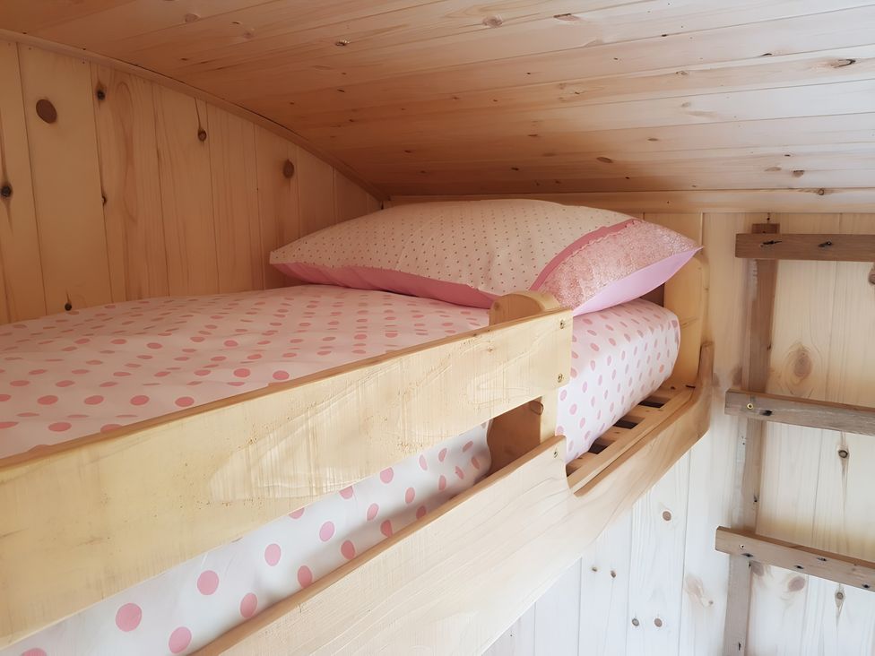 A bunk bed with polka dot bedding at Bryn Mawr Cabin Craven Arms