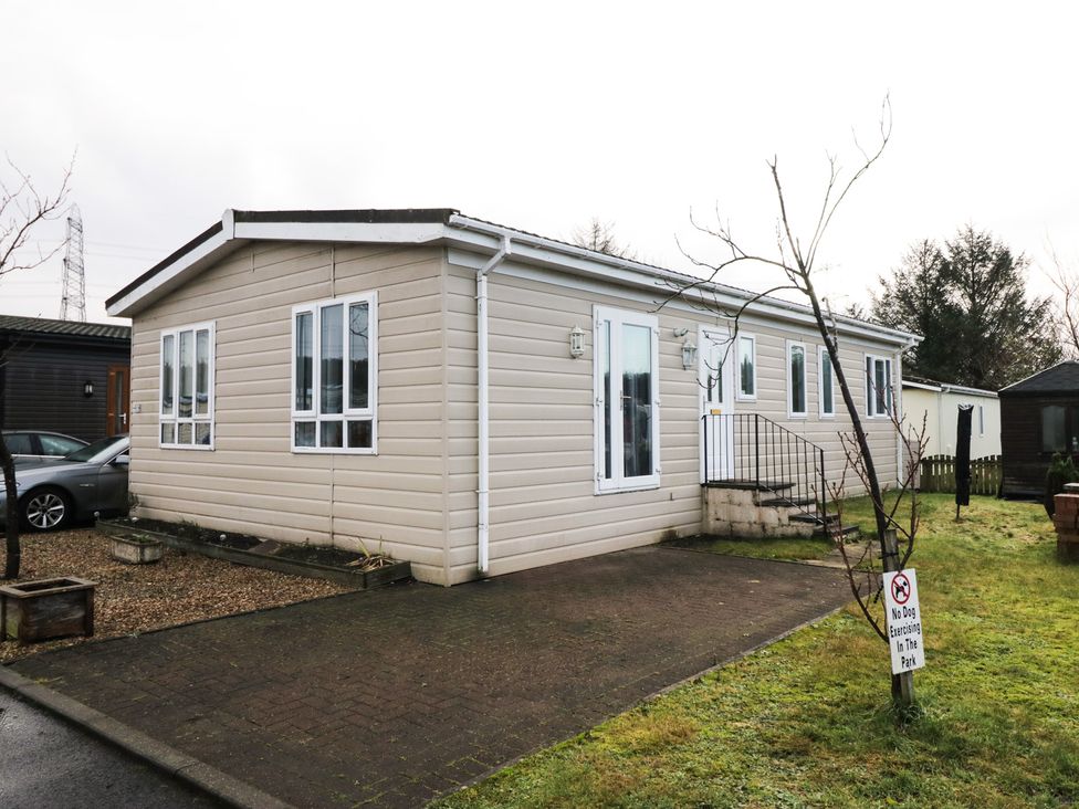 A mobile home with a driveway and steps at Beechtree Lodge 46 Denny