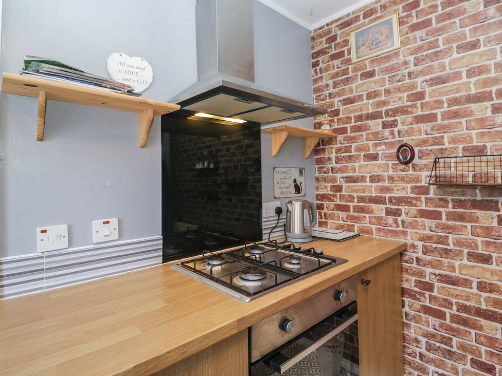 A kitchen with a gas stove and kettle at Beechtree Lodge 46 in Denny
