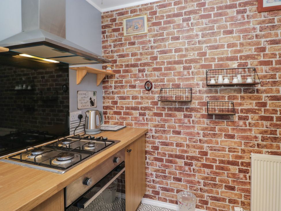 A kitchen with a gas stove and kettle at Beechtree Lodge 46 Denny
