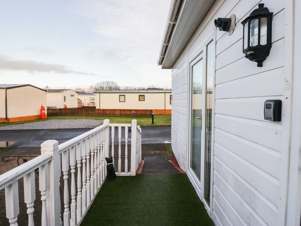 An entrance with a handrail and light fixture at Beechtree Lodge 54 Denny