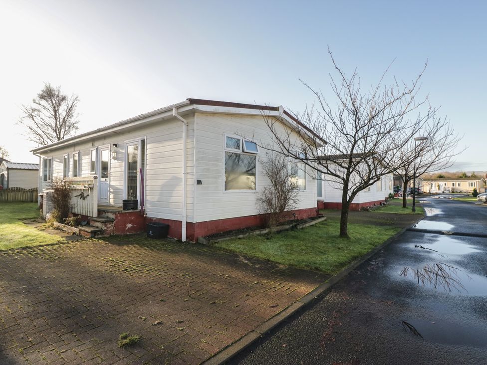 A house with a pathway and tree at Beechtree Lodge 56 in Denny