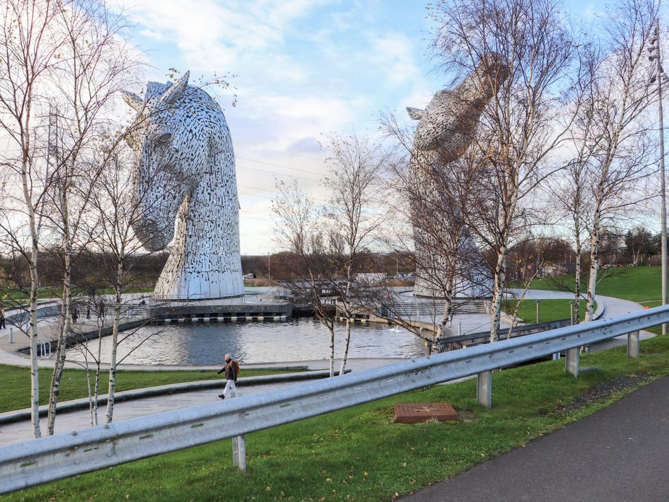 A sculpture of horses next to a water body at Beechtree Timber Lodge 69A Denny