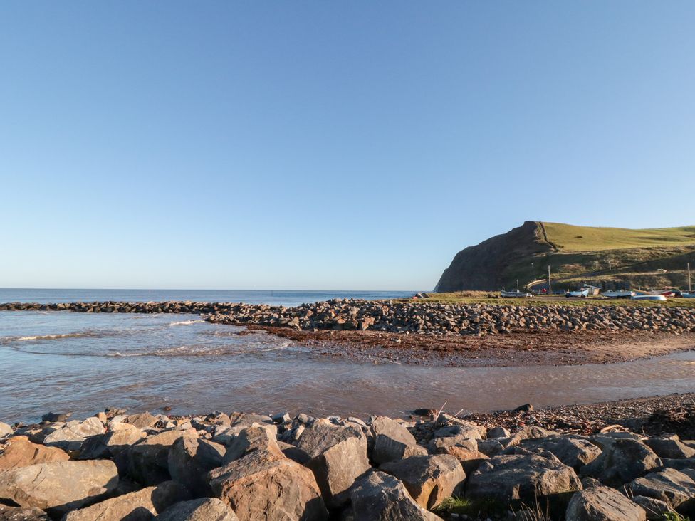 A coastal view with rocks and a hill at Isla’s Sea Forge in Saltburn-by-the-Sea