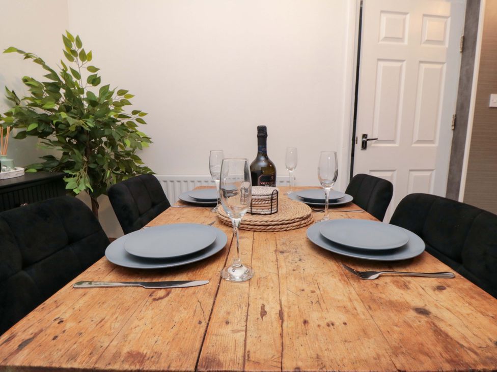 A dining room with a table set for a meal at Isla’s Sea Forge in Saltburn-by-the-Sea