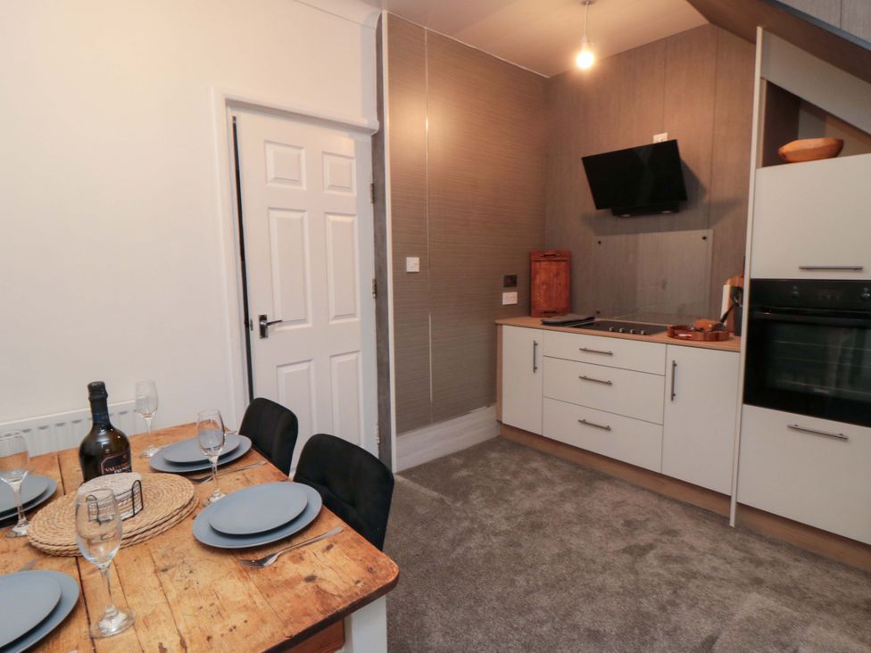A kitchen with dining table and chairs at Isla’s Sea Forge Saltburn-by-the-Sea