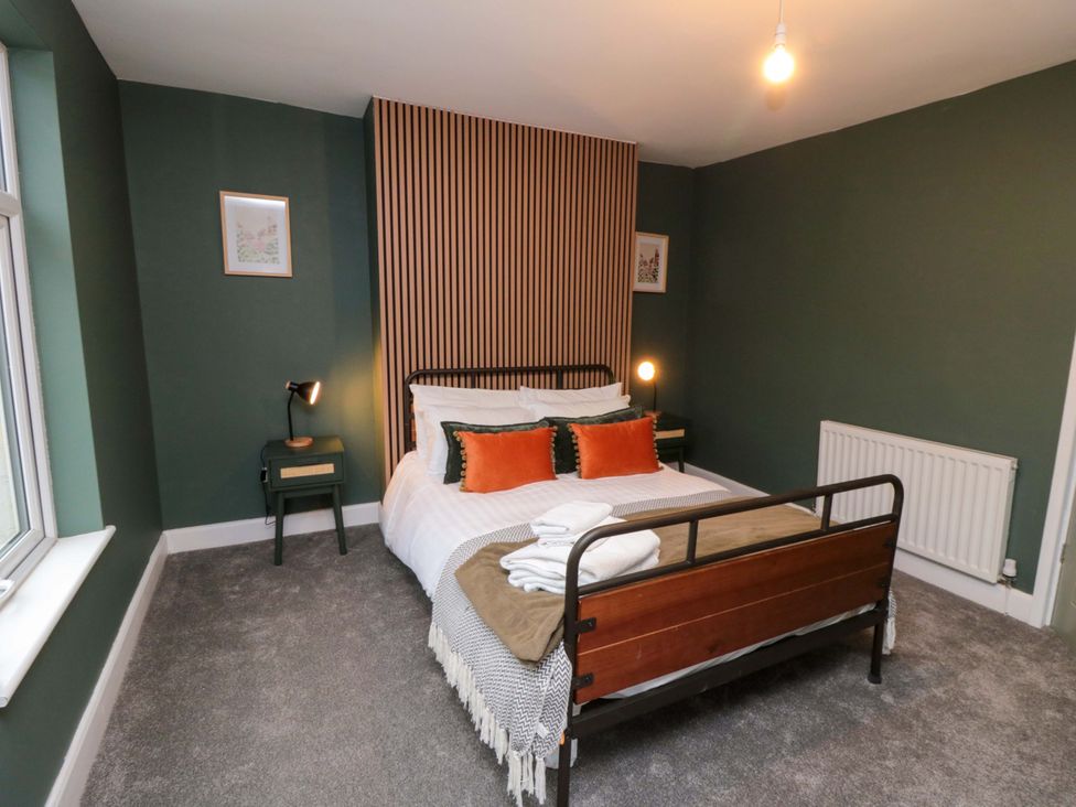 A bedroom with a bed and bedside table at Isla’s Sea Forge in Saltburn-by-the-Sea