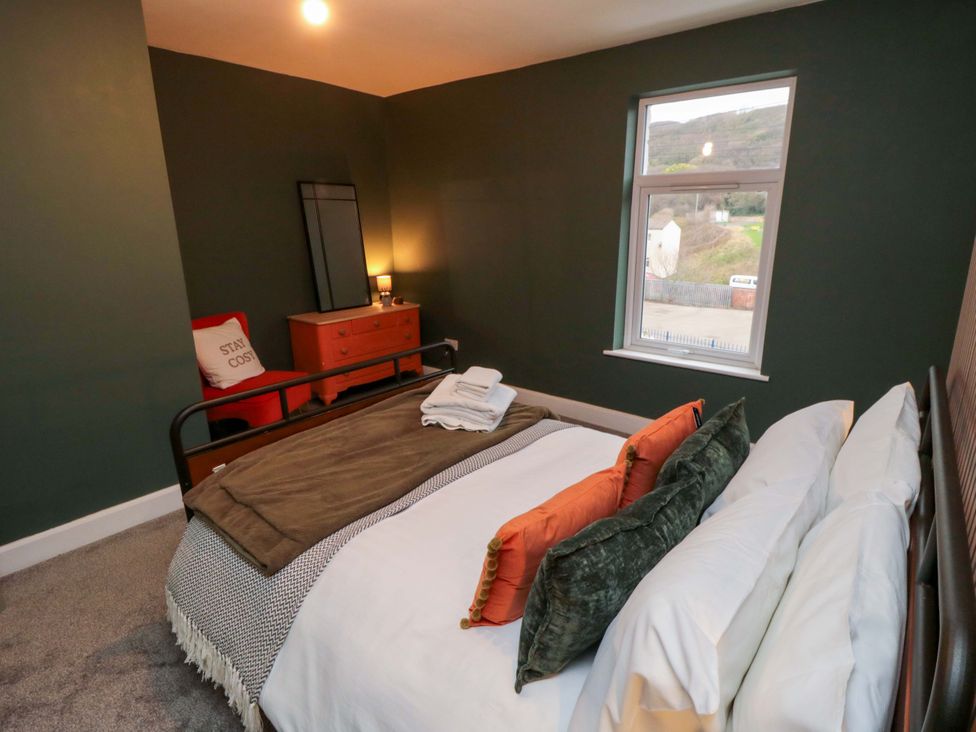 A bedroom with a bed and dresser at Isla’s Sea Forge Saltburn-by-the-Sea