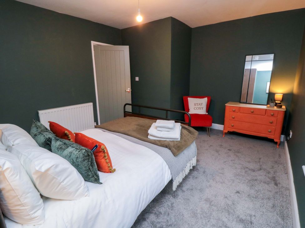 A bedroom with a bed and a dresser at Isla’s Sea Forge Saltburn-by-the-Sea