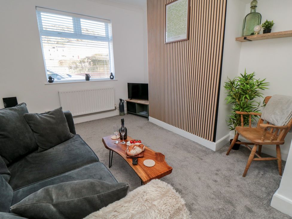 A living room with a sofa and coffee table at Isla’s Sea Forge in Skinningrove