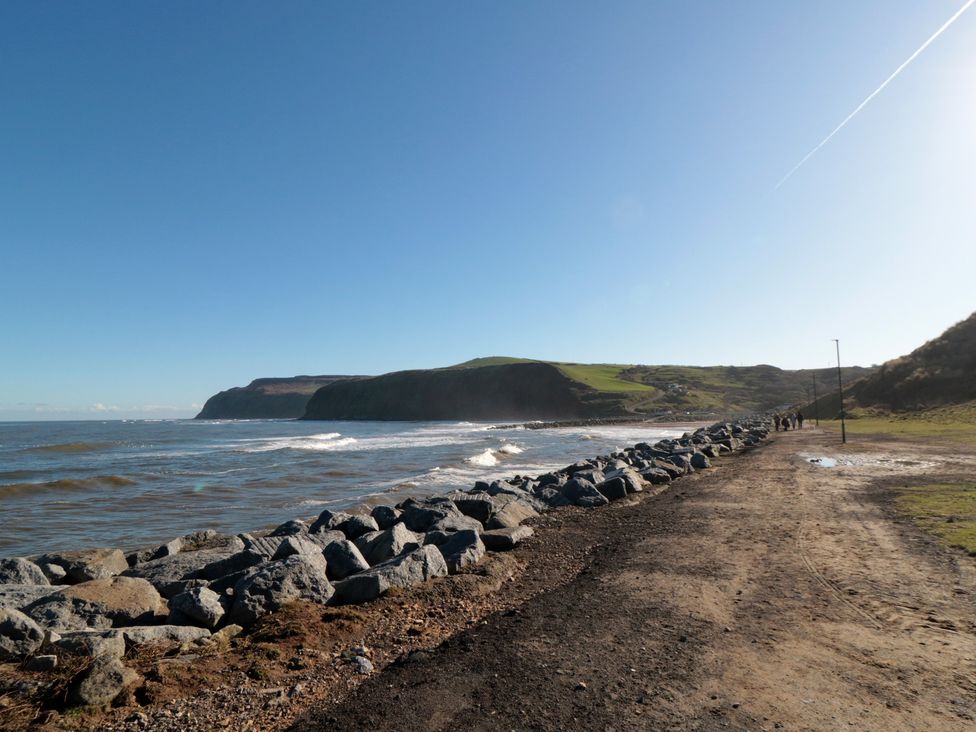 A coastal view with rocks along the path at Isla’s Sea Forge in Skinningrove