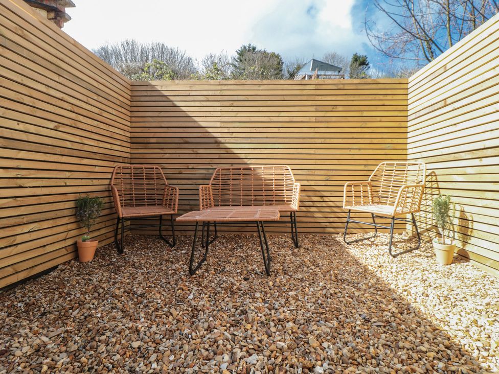 An outdoor seating area with chairs and a table at Isla’s Sea Forge in Skinningrove