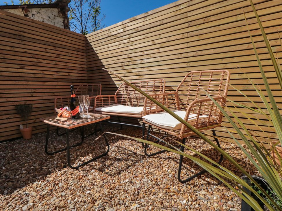 A seating area with chairs and a table at Isla’s Sea Forge in Skinningrove