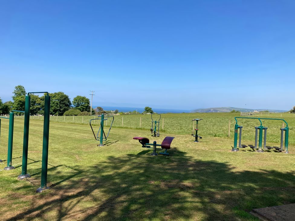 An outdoor fitness area with exercise equipment and a view of the ocean at Caravan 38 Newport