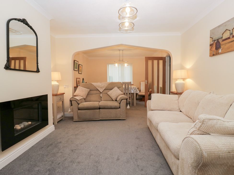 A living room with sofas and a fireplace at Mables in Wigton