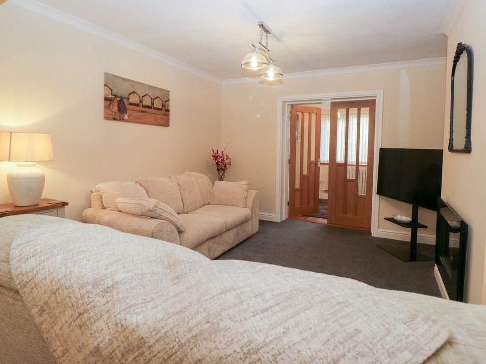 A living room with a sofa and lamp at Mables in Wigton
