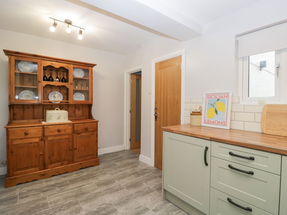 A kitchen with storage cupboard and countertop at Mables in Wigton