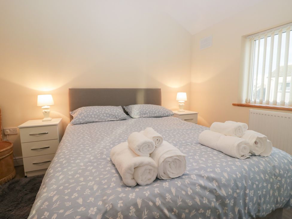 A bedroom with a bed and towels arranged at Mables in Wigton